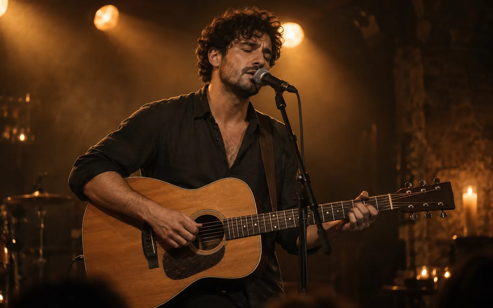 Musician on stage, singing into a microphone